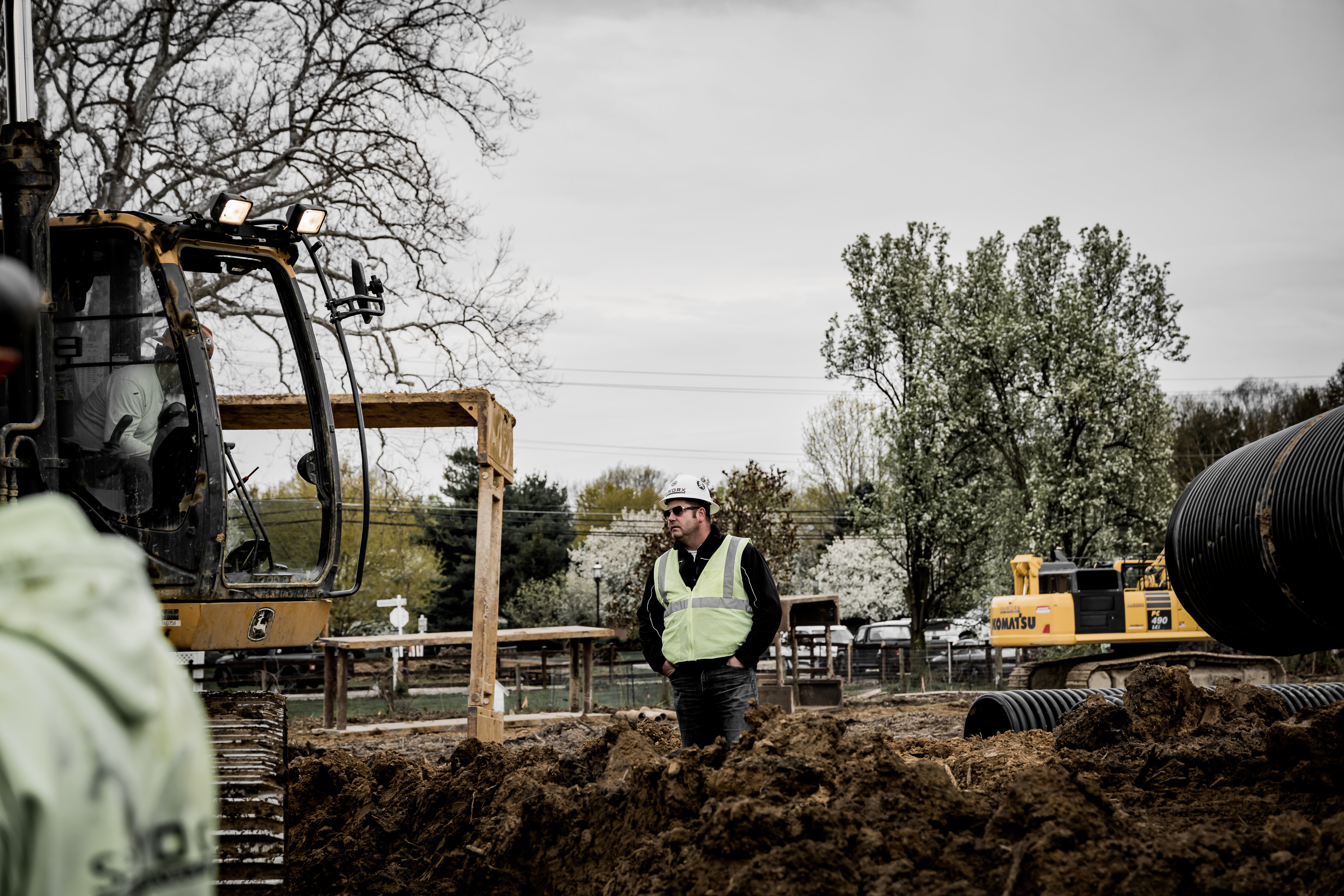 A construction worker walking through a construction site